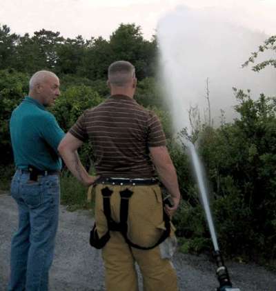 Vice President, Jed Meade, supervises well testing with Dan King Jr. of the Babylon Village Fire Department